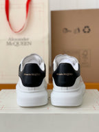 Alexander McQueen Men’s White Leather Oversized Sneakers with Black Heel Tab